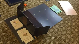 One player board folded into its standing screen shape with dance move cards laid in front